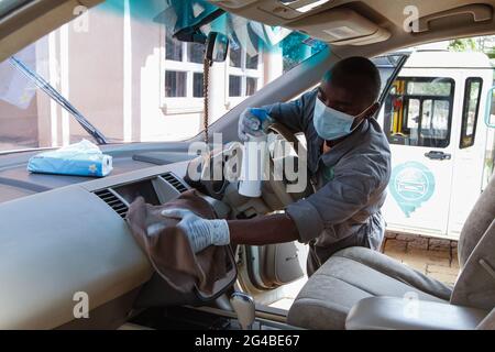 18 juin 2021, Nairobi, comté de Kiambu, Kenya : L'un des membres du personnel de Wash Me Please Mobile Carwash vu assainir une voiture de clients après l'avoir lavée à la maison à Kiambu.The Wash Me Please est une entreprise de démarrage kenyane qui offre des services de lavage de voiture mobile commode depuis le confort de votre maison ou de votre lieu de travail comme un moyen d'aider Combattre la propagation de Covid-19. Wash Me Please est le détail et Carwash Company qui a commencé au début de la pandémie Covid-19. Ils offrent des services mobiles de lavage de voiture aux clients par le biais d'une application mobile que les clients utilisent pour demander leur service. Ce service a offert Banque D'Images