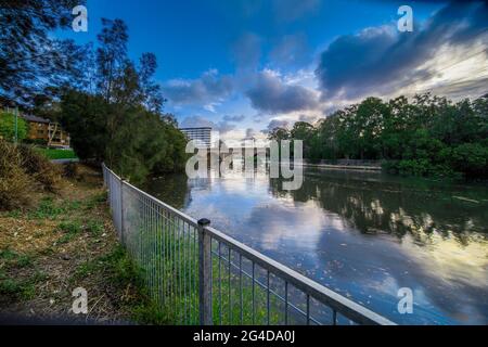 Cuisine la rivière à Canterbury Sydney Australie lors d'un magnifique coucher de soleil après-midi. Des nuages doux et moelleux reflétant des arbres luxuriants et verts Banque D'Images