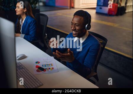 Deux managers souriants travaillent dans le bureau de nuit Banque D'Images
