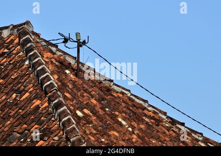 Poteaux électriques sur le toit de la maison Banque D'Images