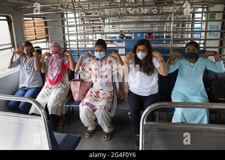 Mumbai, Inde. 21 juin 2021. Les femmes portant des masques faciaux comme mesure de précaution contre la propagation de covid-19 pratiquer l'exercice de yoga à l'intérieur d'un train local à Mumbai.la Journée internationale de yoga est célébrée dans le monde entier le 21 juin chaque année. (Photo par Ashish Vaishnav/SOPA Images/Sipa USA) crédit: SIPA USA/Alay Live News Banque D'Images