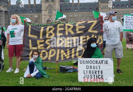 Ottawa, Canada. 21 juin 2021. Les membres de la communauté algérienne au Canada se rassemblent devant le Parlement pour exhorter le gouvernement canadien à condamner l'escalade de la répression en Algérie au 47e Conseil des droits de la personne qui commence aujourd'hui. Ils présentent que depuis la reprise du mouvement pro-démocratie « Hirak » en 2019, les autorités ont intensifié les intimidations et arrêté arbitrairement au moins 6000 personnes, y compris des militants, des journalistes et des défenseurs des droits de l'homme. Ils demandent au Gouvernement de continuer à faire preuve de leadership pour condamner la situation. Credit: Meanderingemu/Alamy Live News Banque D'Images