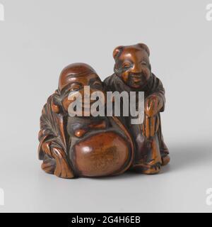 . Le Dieu chanceux Hotei et un garçon chinois. Banque D'Images