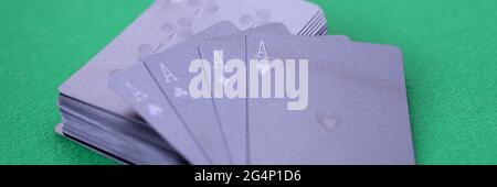 Les cartes à jouer noires avec des as se trouvent sur une table de jeu verte Banque D'Images