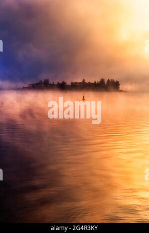 Lever de soleil pittoresque et coloré par temps froid en hiver avec brume et réflexion sur le lac de Jindabyne en Australie. Banque D'Images