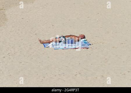 Bournemouth, Royaume-Uni. 23 juin 2021. Beaucoup d'espace pour les amoureux du soleil sur la plage autour de Bournemouth Pier à Dorset tandis que le soleil et le ciel bleu retournent sur la côte sud après une période de temps humide. Credit: Richard Crease/Alay Live News Banque D'Images