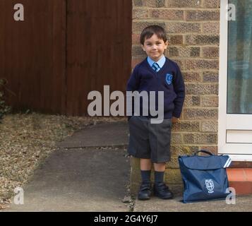 jeune garçon posant dans l'uniforme de l'école à l'extérieur de la maison Banque D'Images