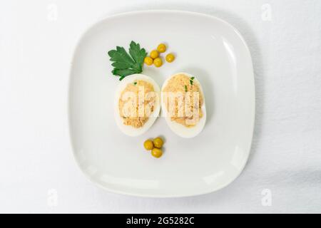 Œufs de thon en conserve avec persil vert sur fond clair. Mise au point sélective Banque D'Images