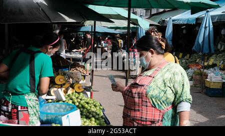 Acheteur et vendeur monnaie authentique changer de mains Klong Toey Market BangkokThailand l'économie de la vente de nourriture les gens achetant le déjeuner Rama 4 intersection Banque D'Images