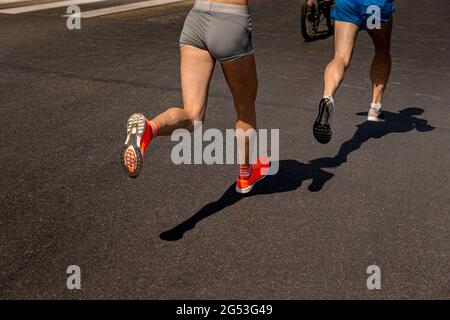 couple joggeurs athlètes femme et homme courir sur la route sombre Banque D'Images