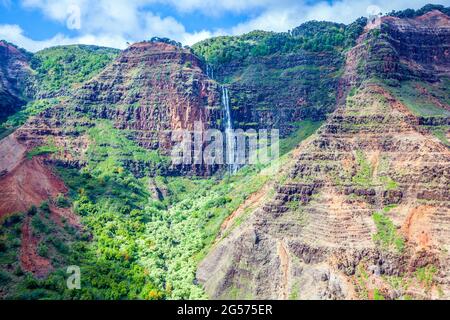 Une cascade coule le long du canyon Waimea de Kauai, près de la côte de Napali ; Kauai, Hawaii Banque D'Images