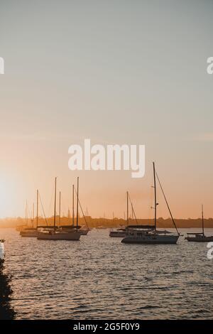 Bateaux et yachts assis sur la rivière au coucher du soleil près de la marina de Yamba sur la rivière Clarence. Banque D'Images