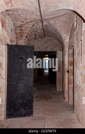 Un couloir avec des arches au plafond et des dalles au sol abrite des cellules de prison de part et d'autre lorsqu'il traverse un bloc cellulaire à la vieille prison de Jedburgh Banque D'Images