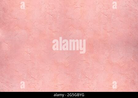 Texture de plâtre de mur de stuc rose - un gros plan d'un mur de plâtre Banque D'Images
