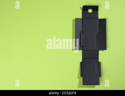 boîte noire protectrice intérieure pliable en carton ondulé pour les emballages avec articles cassables sur fond vert, pour la parfumerie, l'espace de copie Banque D'Images