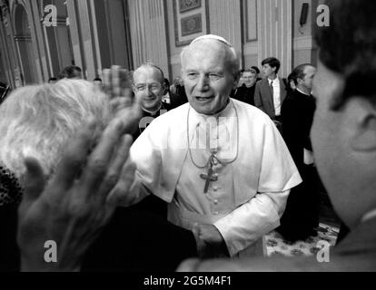 Le Pape Jean-Paul II salue les fidèles à Rome, en 1988. Derrière lui se trouve le Cardinal Edmund Szoka. Banque D'Images