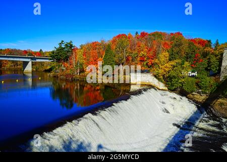 Les chutes et le pont en automne avec des arbres colorés et le ciel bleu. Parc des chutes Montmorency (Parc de la chute-Montmorency), Québec, Canada, 2016. Banque D'Images