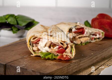 Shawarma ou burrito maison ou rouleau de poulet avec légumes et sauce Banque D'Images