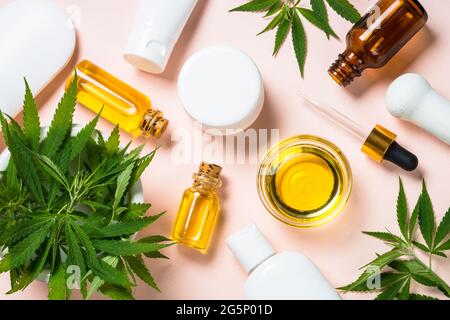 Huile de cannabis, crème, savon et feuilles fraîches à blanc. Banque D'Images