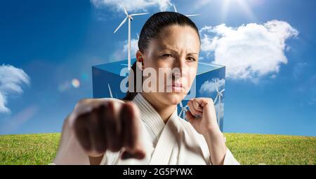 Image numérique composite du portrait d'une femme mariteuse caucasienne contre des éoliennes Banque D'Images