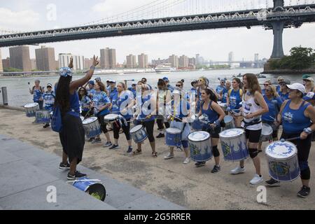 Fogo Azul: All-Women Samba Drum Line. La première ligne féminine de tambours de Samba Reggae de New York se présente le dix-septième 2021 au Brooklyn Bridge Park à Brooklyn, New York. Banque D'Images