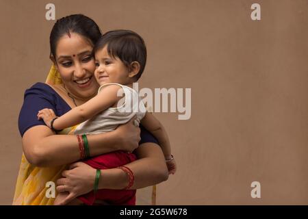 Une femme tenant son bébé avec affection. Banque D'Images