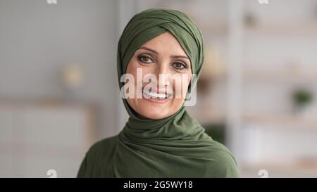 Portrait d'une femme musulmane senior souriante dans un hijab traditionnel en intérieur Banque D'Images