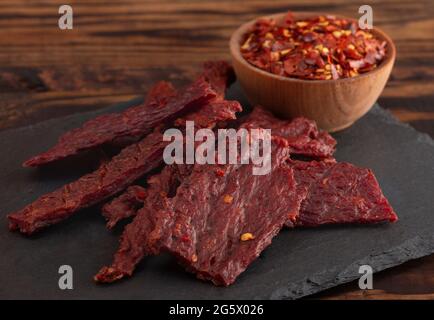 Une Pile de la charque chaude et épicée avec des flocons de piment rouge Banque D'Images