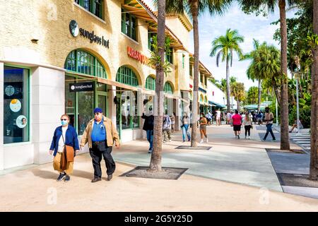 Miami Beach, États-Unis - 17 janvier 2021 : célèbre rue commerçante de Lincoln Road avec des gens qui marchent à proximité des magasins boutiques Sunglass Hut Retail le jour d'hiver ensoleillé Banque D'Images