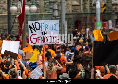 Ottawa (Ontario), Canada - le 1er juillet 2021 : un panneau portant la mention « pas de fierté pour le génocide » est organisé à titre de militants qui se sont orientés vers la colline du Parlement pour protester contre Cana Banque D'Images