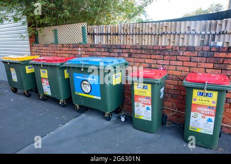 Recyclage des poubelles dans une rue latérale à Sydney pour le recyclage des bouteilles, du papier et du carton et des poubelles rouges pour les déchets généraux, Australie Banque D'Images