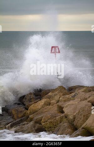 Une vague s'écrasant sur UN brise-lames, Groyne à Hengistbury Head Beach pendant UNE tempête hivernale. ROYAUME-UNI Banque D'Images