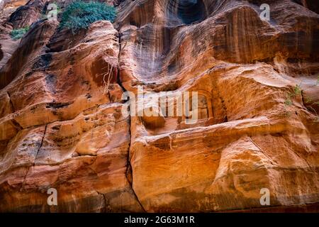 Sculptures anciennes à l'intérieur de la roche de grès greened à Petra, en Jordanie Banque D'Images
