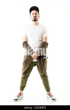Style coq expressif jeune homme barbu stylé posant avec le gilet des épaules. Portrait du corps entier isolé sur fond blanc Banque D'Images