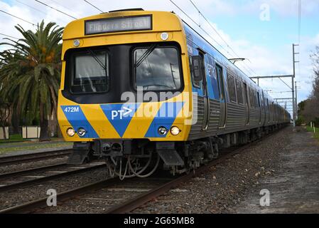 Un service de Flinders Street, géré par le métro Melbourne, peu après avoir quitté la gare d'Ormond. La saleté est clairement visible sur le train Comeng. Banque D'Images