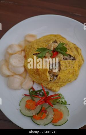 Le nasi Pattaya, est un plat de riz frit d'Asie du Sud-est fait en couvrant ou en enveloppant le riz frit au poulet, dans un œuf ou une omelette frits. Banque D'Images