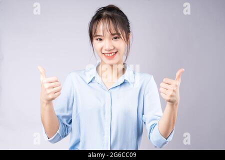 Portrait of young woman on white background Banque D'Images