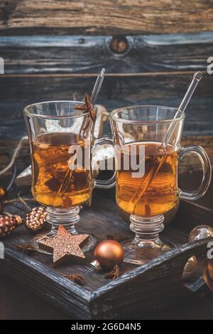 Deux verres avec thé sur un plateau en bois décoré de noël photo verticale stock. Banque D'Images