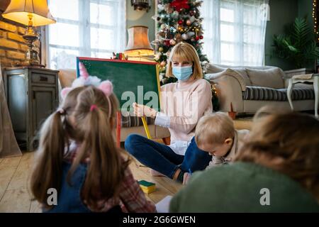 Enfant avec masque et enfants jouant ensemble. Éducation, concept de coronavirus Banque D'Images