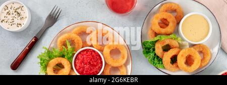 Panorama calamars Rings. Rondelles de calmars frits, assiettes de fruits de mer avec vin et diverses sauces, plat plat de dessus Banque D'Images