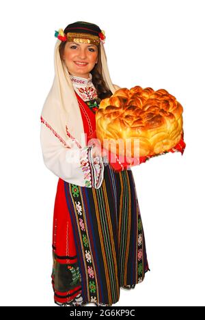 Jeune fille paysanne avec costume traditionnel bulgare de folklore et pain de levain dans le portrait de main isolé Banque D'Images