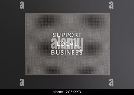 Support local Business texte écrit sur tableau noir sur fond noir Banque D'Images