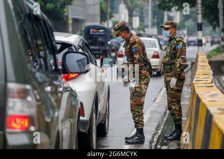 Le personnel de l'armée limite les déplacements de la population pendant le confinement strict à l'échelle nationale pour enrayer la pandémie du coronavirus, à Dhaka, au Bangladesh, le 7 juillet 2021. Banque D'Images