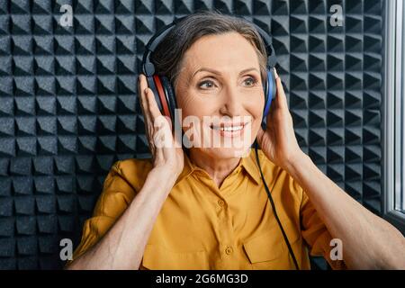 Test auditif chez une femme âgée. Une femme mature positive pendant un examen auditif et une audiométrie à la clinique d'audition Banque D'Images