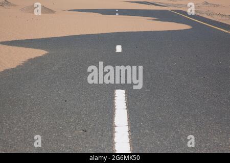 Sable couvrant la route à Dubaï, Émirats Arabes Unis. Banque D'Images