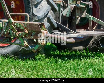 Fuessen, Allemagne - 23 juillet 2019 : gros plan d'un attelage de remorque obsolète sur un tracteur sur une surface herbeuse. Banque D'Images