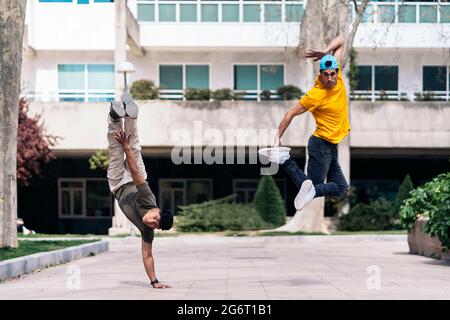 Deux amis multiethniques dansant dans le parc et faisant des coups de danse de pause. Banque D'Images