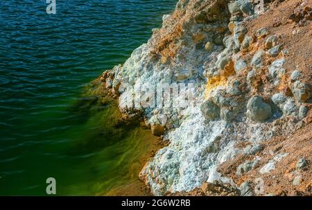 Extraction de résidus miniers et de déchets toxiques sur les rives d'une mine de cuivre à ciel ouvert abandonnée. Les cristaux de sulfate de fer et d'eau contaminée se rapprochent Banque D'Images