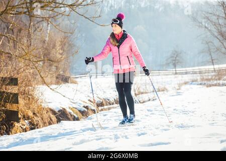 Femme ski comme sport d'hiver dans la neige paysage Banque D'Images