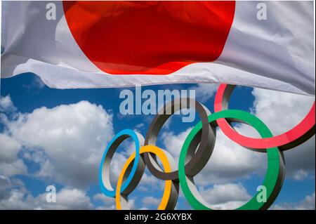 RIO DE JANEIRO - MARS 2016 : un drapeau japonais flotte dans le vent devant les anneaux olympiques debout sous un ciel bleu vif. Banque D'Images